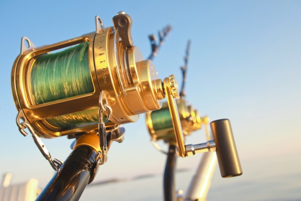 fishing_reels_and_rod_lit_by_sunset_95447152-1 fishing_reels_and_rod_lit_by_sunset_95447152-1